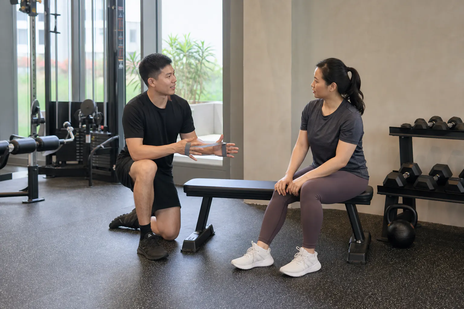 Trainer answering a client question between exercises
