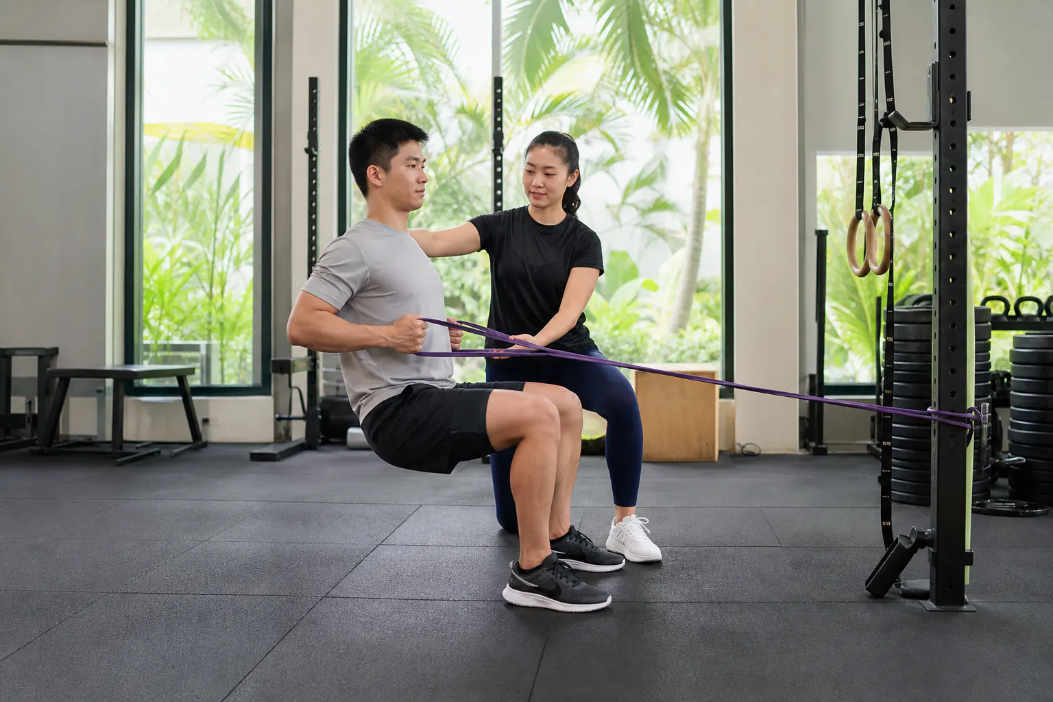 Trainer coaching safe squat technique